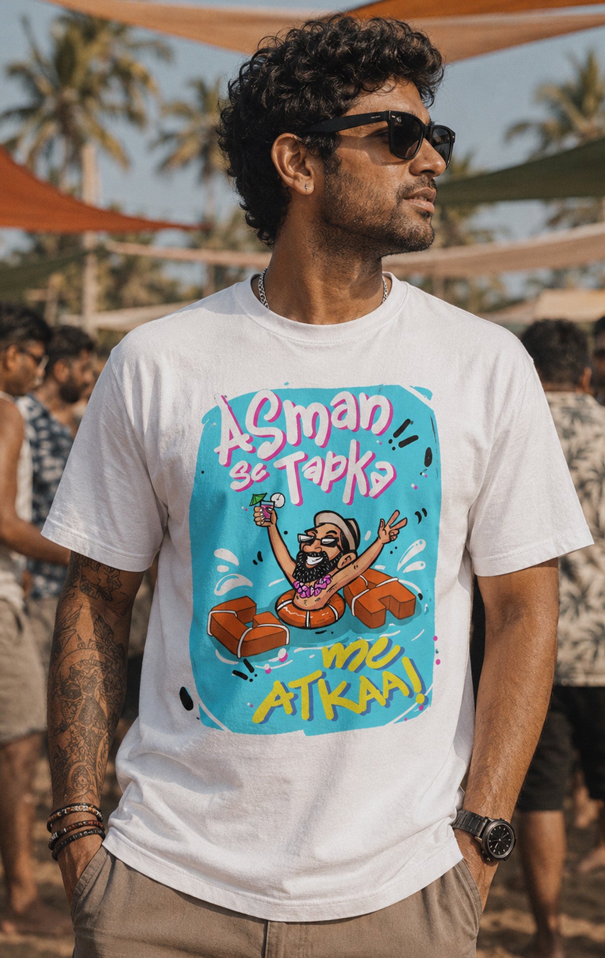 White short-sleeve graphic t-shirt featuring a cartoon man chilling in a pool float with Goa vacation text