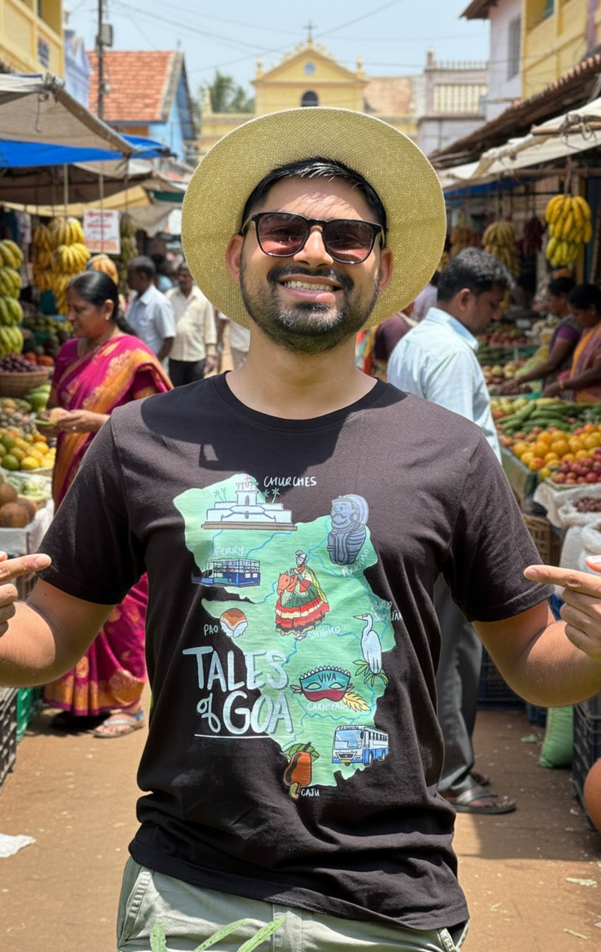 Man wearing a black “Tales of Goa” t-shirt featuring an illustrated map of Goa, showcasing Goan culture, festivals, and landmarks — part of the Oipatrao x Tales of Goa collection.